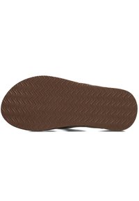Sole of a shoe with a patterned brown rubber bottom, featuring wavy grooves for traction and a rounded toe shape.