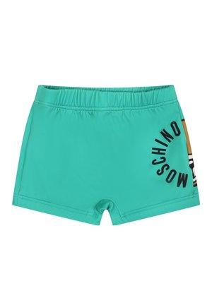 Pantaloni da bagno turchesi con vita elastica, caratterizzati da una stampa di testo nera e un accento con motivo sul lato. Texture del tessuto morbida.