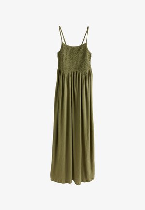 Olive green maxi dress with thin straps, smocked bodice, and flowing skirt. Made of lightweight fabric with a textured finish.