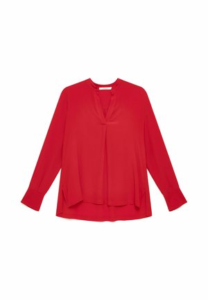 Blouse rouge à manches longues avec fente en V au col, coupe ample et larges poignets, présentée à plat sur fond blanc.