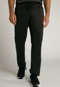 Pantaloni sportivi neri con vita regolabile con cordino, caratterizzati da una vestibilità slim, una texture liscia e tasche con zip sui lati.