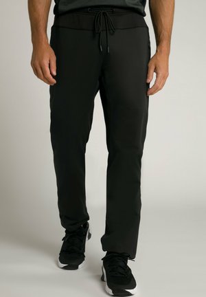 Zwarte sportbroek met een trekkoord in de taille, met een slim fit, een gladde textuur en ritszakken aan de zijkanten.