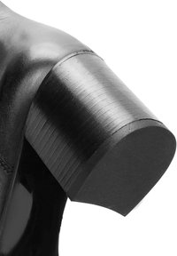 Czarne skórzane buty z masywnym obcasem o gładkim wykończeniu i zaokrąglonym brzegu, podkreślające elegancki i nowoczesny design.