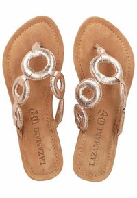Sandali flip-flop color oro rosa con dettagli metallici circolari, suola in suede beige e cuciture lungo i bordi. Il logo del marchio è visibile.