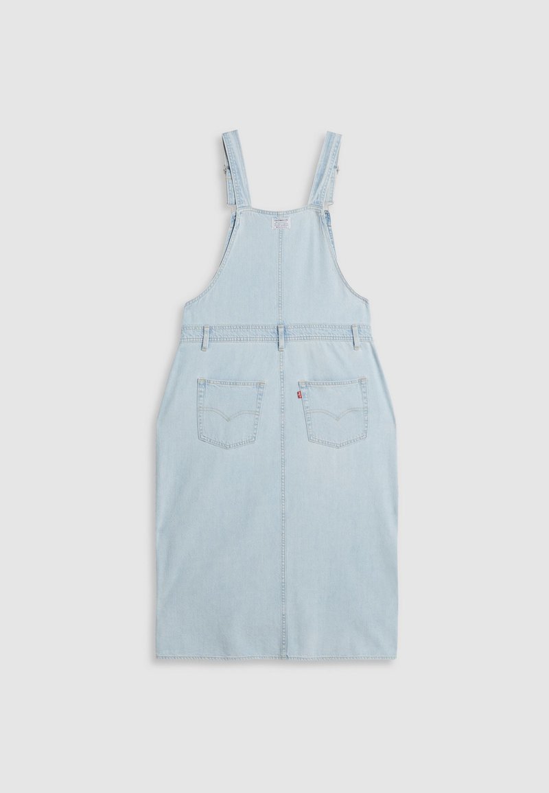 Helles blaues Jeans-Overallkleid mit verstellbaren Trägern, zwei vorderen Taschen und geradem Schnitt. Mit einer hinteren Tasche mit Markenlogo.