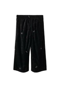 Čierne široké sametové nohavice s elastickým pásom a malými bielymi vyšívanými kvetinovými detailmi rozmiestnenými po látke.