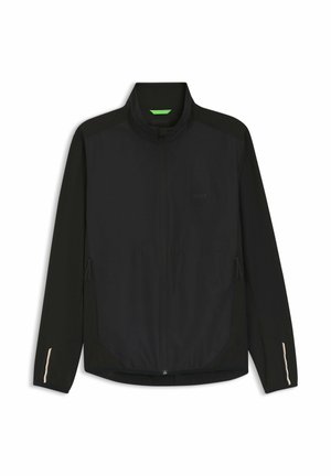 Veste légère noire à fermeture éclair, manches longues, col montant, poches zippées latérales et accents réfléchissants subtils sur les poignets.