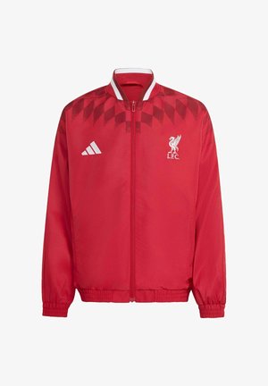 Rød sportssweatshirt med lynlås med hvid Adidas-logo på højre bryst og hvid Liverpool FC-emblem på venstre bryst, med et mønstret skulderstykke.