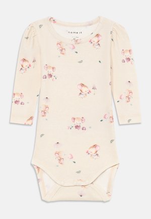 Long-sleeve baby bodysuit in light beige cotton featuring a whimsical mouse pattern, snap bottom closure, and gentle gathering at shoulders.