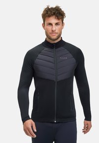 Giacca nera con zip, maniche lunghe testurizzate e parte anteriore imbottita a motivo chevron. Presenta tasche laterali e colletto alto.