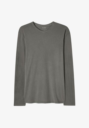 Pilkas ilgomis rankovėmis marškinėliai. Pagaminti iš švelnios medvilnės, turi apvalią iškirptę, tiesią apačią ir minimalias siuvimo detales.