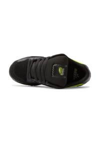 Black athletic shoe with mesh and synthetic upper, featuring neon green accents, round toe, and flat black laces. Textured outsole visible.