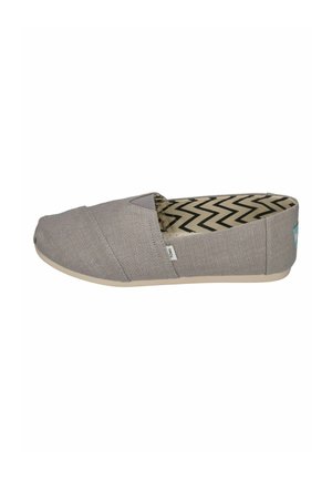 Gray slip-on canvas shoe with rounded toe, beige sole, zigzag patterned interior, and small side fabric label.