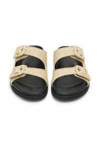 Två remsandaler med en vävd beige ovandel med dubbla spännen och en svart gummisula, som erbjuder hållbarhet och komfort.