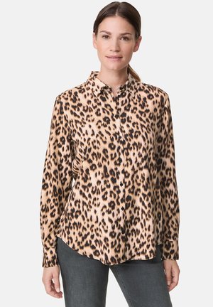 Leopard print button-up shirt in beige and black, featuring a collar, long sleeves, and a soft, smooth texture. Casual fit with black buttons.