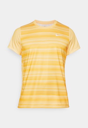 Yellow athletic t-shirt featuring horizontal stripes in varying shades, short sleeves, and a small white logo on the left chest.