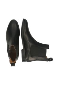 Par de botas Chelsea de cuero negro con paneles laterales elásticos y tiradores, mostradas desde vistas superior y lateral sobre fondo blanco.