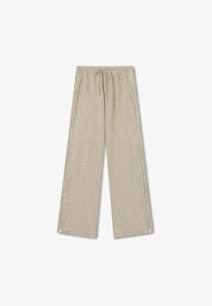 Beežid, laiad püksid kummipaelaga vööl, mille külgseintel on dekoratiivsed silmadetailid, lisamaks välimusele huvitavust.