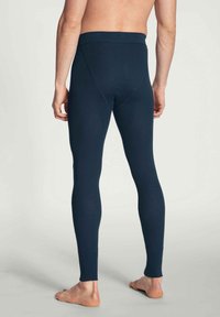 Leggings lunghi blu navy realizzati in un materiale elasticizzato, caratterizzati da un design aderente, una vita alta e dettagli di cucitura minimi.