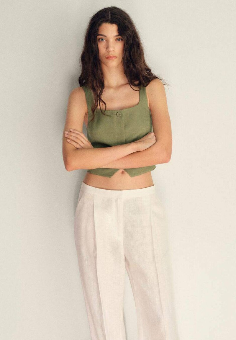 Olivově zelený crop top se čtvercovým výstřihem a knoflíkovým detailem, kombinovaný s bílými lněnými kalhotami s vysokým pasem a rovný střih.