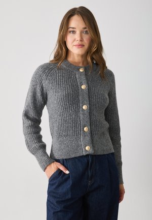 Gray ribbed cardigan with a round neckline, featuring gold-tone buttons down the front and fitted long sleeves, paired with dark jeans.
