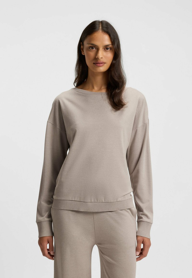 Beiges Langarmshirt mit rundem Ausschnitt und gerippten Bündchen, aus weichem Material gefertigt. Verfügt über eine lockere Passform und ein passendes Taillenbund-Detail.