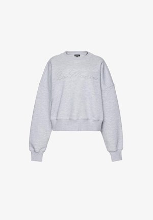 Šviesiai pilkas ilgomis rankovėmis megztinis su apvalia iškirpte, su ribotais rankogalais ir apačia, subtilia kursyvo stiliaus „La Mania“ logotipu išsiuvinėtu per krūtinę.