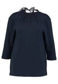 Top de manga larga en azul marino oscuro con un escote gathered y un detalle de corbata a rayas. Presenta aberturas laterales y una silueta de ajuste relajado. Tejido suave.