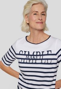 White and navy striped T-shirt with short sleeves, round neckline, and text "MAKE IT SIMPLE" in decorative font across the chest.