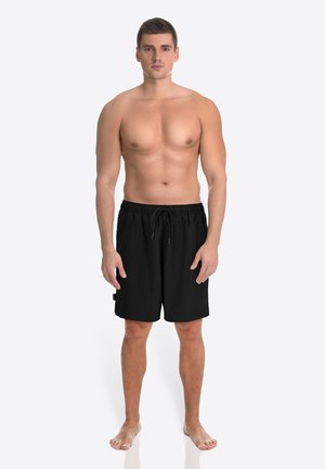 Schwarze Badehose mit elastischem Bund und Kordelzug. Hergestellt aus leichtem Stoff, mit seitlicher Tasche und lockerer Passform.