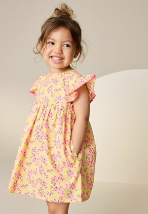 Yellow floral dress with pink accents, short flutter sleeves, gathered waistline, and side pockets, featuring small pink and purple flowers.