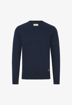 Maglione blu navy a V con maniche lunghe, realizzato in un tessuto morbido. Presenta una piccola patch con il marchio sul lato sinistro inferiore.