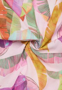 Bunt gewebter Stoff mit abstrakten Blattformen in Pink, grün, orange und gelb, mit verschiedenen Linien und Texturen auf einem hellen Hintergrund.