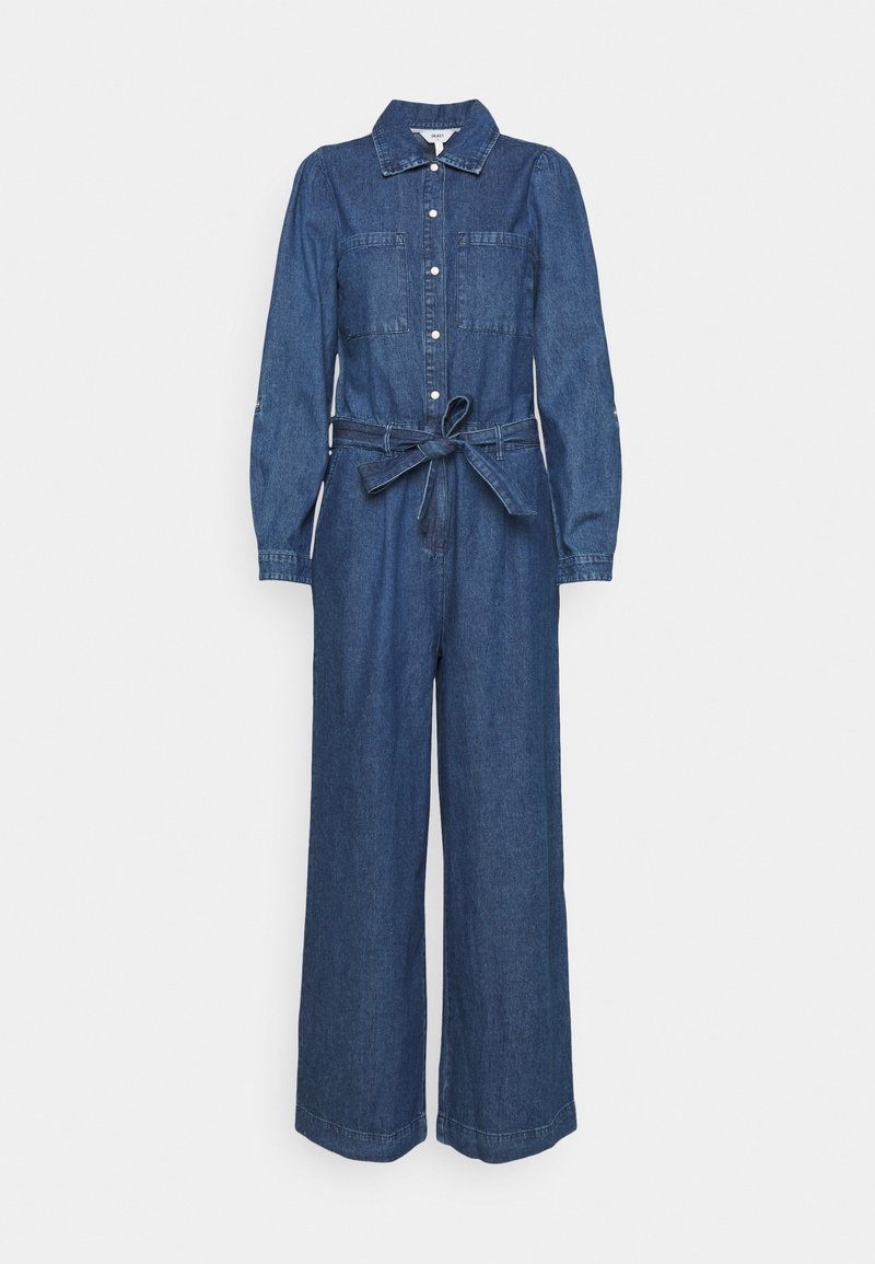 Combinaison en denim avec manches longues, deux poches poitrine, boutonnage devant et taille ceinturée. Design à jambes larges dans une teinte bleu foncé.