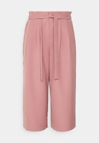Pale pink culotte pants with a high waistband, pleated front, and detachable tie belt. Soft fabric texture with side pockets.
