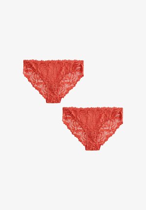 Kaks paari punase pitsiga naiste hipster aluspükse lillemustritega valgel taustal.