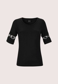 Black t-shirt with short sleeves featuring floral lace accents at the cuffs. Soft fabric, round neckline, and a fitted silhouette.