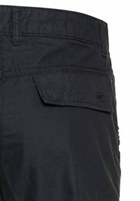 Black pants with a wrinkled texture, featuring stitched seams, a back pocket with a flap, and a small logo near the waistband.