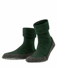 Calze verdi in maglia con risvolto morbido, dotate di una suola in fleece grigia con punti bianchi per una migliore aderenza.