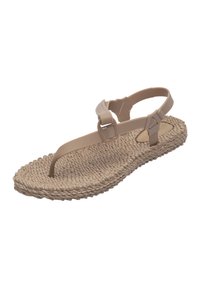 Beige woven sandals with a textured sole, featuring a thin toe strap and adjustable ankle strap for secure fit.