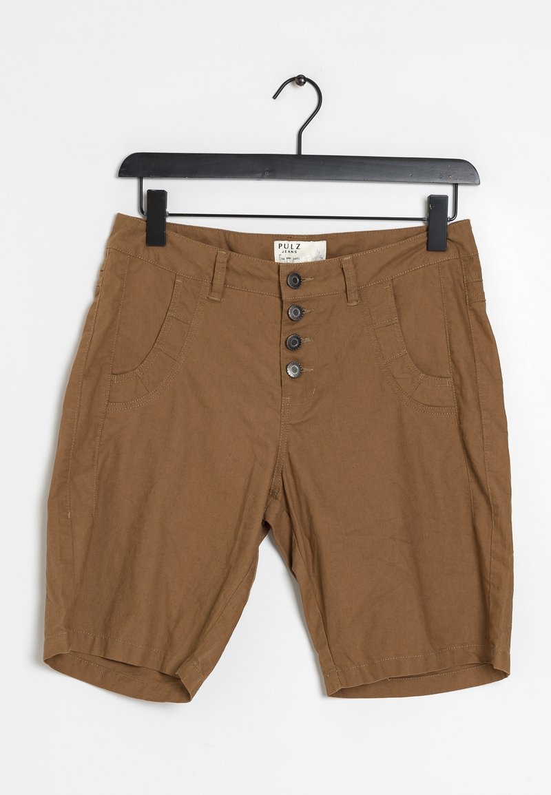 Shorts marron mi-genou avec quatre boutons sur le devant et des poches latérales suspendus sur un cintre noir.