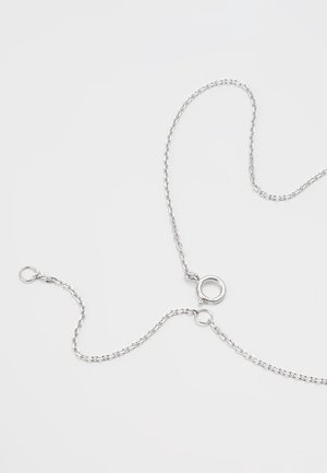 Zarte Silberkette mit kleinen ovalen Gliedern und einem runden Federringverschluss auf hellgrauem Hintergrund.