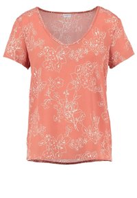 T-shirt pêche à col en V avec manches courtes, présentant des motifs floraux blancs en contour. Tissu doux avec une coupe décontractée et un ourlet droit.