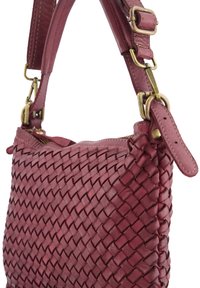 Woven leather handbag in burgundy, featuring a zip closure, adjustable strap, and brass hardware accents. Compact design and textured finish.