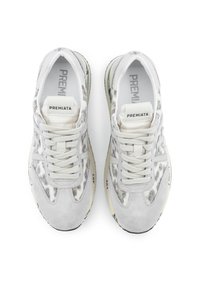 White sneaker with a textured gray and silver pattern, suede accents, round toe, and flat laces. Brand label visible on tongue.