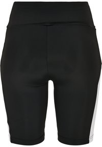 Pantalones cortos deportivos negros con textura suave, diseño de talle alto y paneles laterales blancos contrastantes. Detalles de costura visibles.