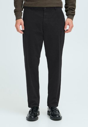 Black trousers in a slim fit with a flat front, made of lightweight fabric. Features a single button closure and belt loops.
