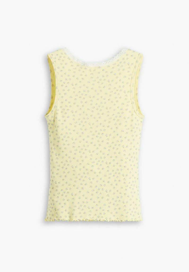 Top amarillo sin mangas con un estampado floral, hecho de tela suave, con un dobladillo en forma de ondas y amplias sisas para mayor comodidad y facilidad al llevarlo.