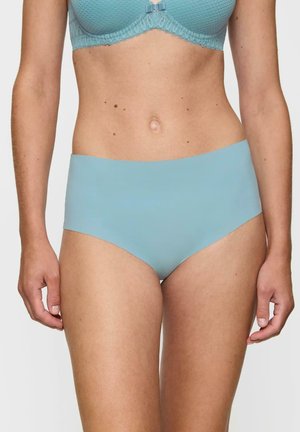 Jasnoniebieskie figi o wysokim stanie z gładkim, matowym wykończeniem. Brak widocznych szwów lub wzorów, zaprojektowane z myślą o komforcie i eleganckim dopasowaniu.