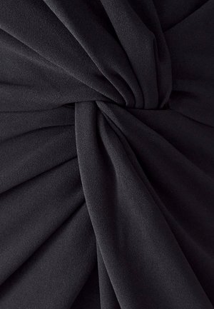 Black fabric featuring deep pleats with a smooth texture. Material appears lightweight and airy, with a soft and flowing drape.